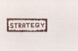 © Ion - The word Strategy inside a rectangle all made using coffee beans shot from above ,aligned to the left.