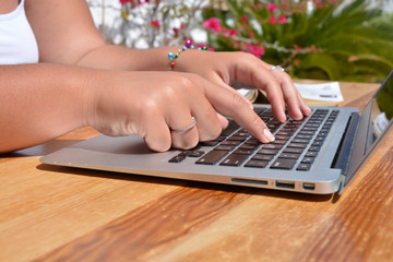 hands typing on laptop