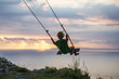 © Maygutyak - The back of the boys Swings are playing on the beach