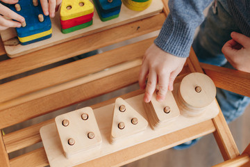 child playing with wooden educational toys