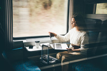 Freelancer Girl Working With Laptop In The Train, Business Travel Or Technology Concept.