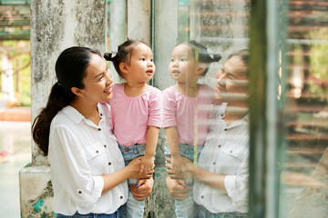 Curious mother and daughter in zoo