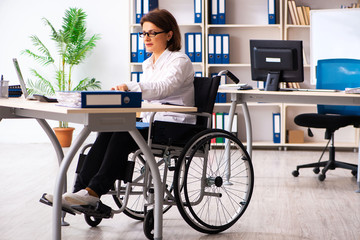 Female employee in wheel-chair at the office  