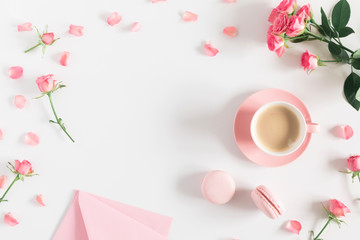 Flowers composition romantic. Flowers roses and rose petals, macaroon, cup coffee on white background. Happy women's day. Valentine's Day. Flat lay, top view 