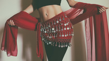 Close Up Stomach Of Belly Dancer With Scarf.Toned Photo.