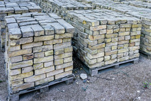 Old Used Bricks, Stacked Into Cubes On Pallets