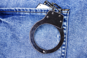 Police steel handcuffs in back jeans pocket