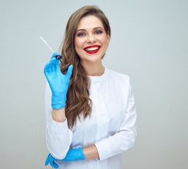 smiling doctor in blue gloves holding syringe for beauty injection.