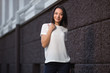 © Wrangler - Happy young fashion woman in white t-shirt on city street