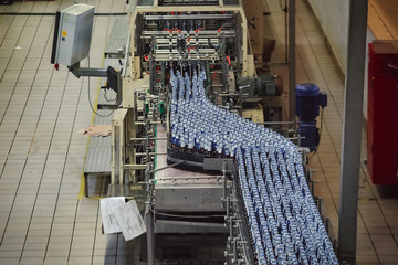 Modern automated beer bottling production line. Beer bottles moving on conveyor