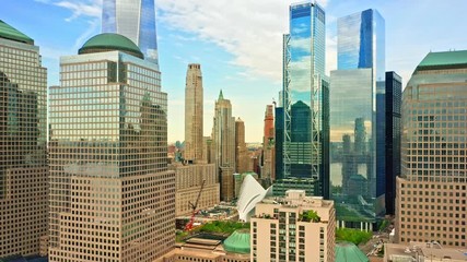 Wall Mural - Aerial drone footage of downtown New York skyline. The camera pulls back from Lower Manhatttan skyline between tall skyscrapers