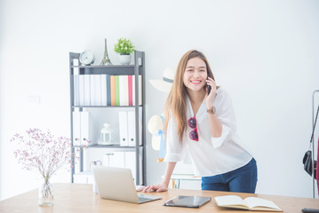 Wall Mural - Portrait beautiful asian designer woman working with computer in tailer fabric fashion small business shop. SME business concept