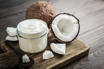 Coconut cream in a glass jar with fresh coconut