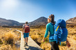 © Maridav - New Zealand Hiking Couple Backpackers Tramping At Tongariro National Park. Male and female hikers hiking by Mount Ngauruhoe. People living healthy active lifestyle outdoors