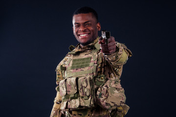 Wall Mural - american man in camouflage suit aiming with a pistol