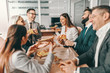 © Dusan Petkovic - Small group of happy colleagues in formal wear chatting and eating pizza together for lunch. Alone we can do so little, together we can do so much.
