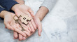 © paulaphoto - Closeup real estate or couple hands holding and giving key house with copy space isolated on marble background. Hands of man and woman buy new house. Together love startup new family concept banner