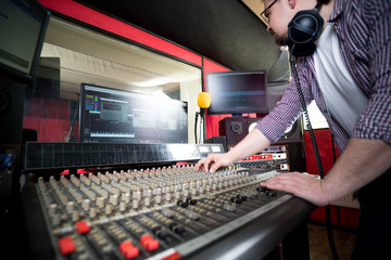 Wall Mural - Sound producer working at recording studio using soundboard and monitors