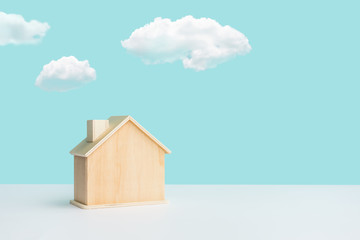 Model of House(home) made by wood with sky on pastel color background