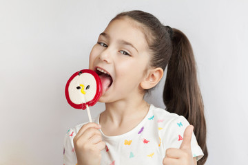 Beautiful cute little child girl eating big lollipop 