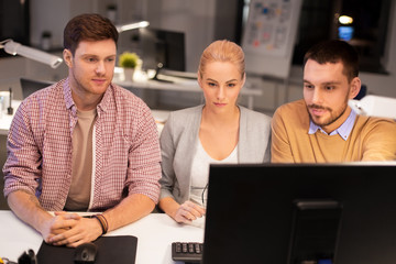 Canvas Print - business, deadline and technology concept - coworkers with computer working late at night office