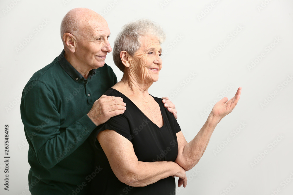 Portrait of senior couple on white background