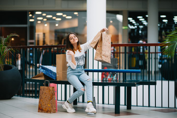 Wall Mural - Shopping time, teenage girl with shopping bags at shopping mall. Shopping concept