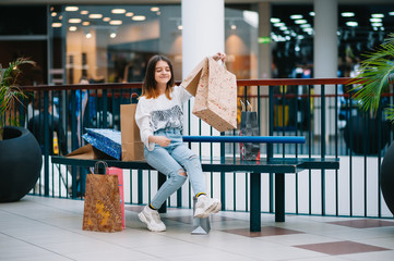 Wall Mural - Shopping time, teenage girl with shopping bags at shopping mall. Shopping concept