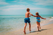 © nadezhda1906 - happy girl and boy run play with waves on beach