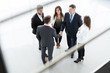 © opolja - Top view of business people shaking hands, finishing up a meeting - Welcome to business.