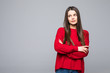 © F8  \ Suport Ukraine - Portrait of doubting displeased popular european woman in red loose sweater and careless expression, being disappointed or unimpressed over gray wall