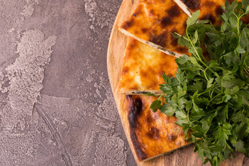 Wall Mural - Khachapuri Megrelian with spinach and parsley. Pita bread with cheese