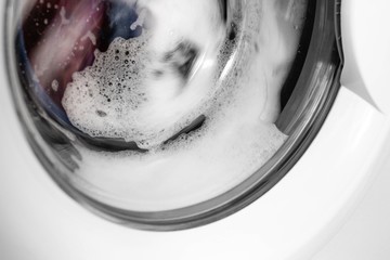 Washing machine washes things. Close up. Isolated on white background