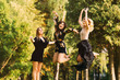 © Ivan - girls are having fun in the park. smiles and jumps against the b