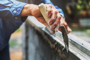 Wall Mural - closeup hand of worker are plastering