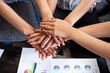 © Watcharin - Group of young people hands stacked together,the collaborator,for trust and success of deal,union,teamwork concept
