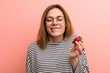 © Asier - Portrait of young woman tasting a fresh strawberry