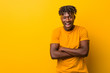 © Asier - Young black man wearing rastas over yellow background laughing and having fun.