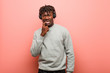 © Asier - Young rasta black man listening to music with headphones relaxed thinking about something looking at a copy space.