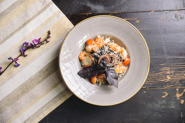 Wall Mural - black spaghetti with octopus, shrimp, cherry tomatoes and basil