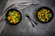 © Westend61 - Two bowls of mixed green salad with Hokkaido pumpkin and walnuts