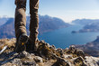 © Westend61 - Italy, Como, detail of hiking boots on the rock