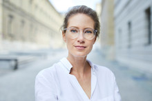 Portrait Of Confident Woman Wearing Glasses And White Shirt In The City