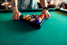 Close-up Of Billiards Player Arranging Balls On Table