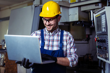 Wall Mural - Factory engineer checks the quality of the manufactured part