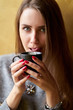© Kiryl Lis - Young pretty girl with long hair drinking coffee in the cafe and licking her lips in the foam.