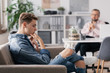 © Photographee.eu - Professional therapist and teenage boy ignoring him during appointed meeting