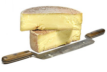 Organic Allgäu Hay Milk Cheese Wheel With Vintage Cheese Knife Isolated On White Background