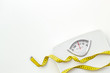 bathroom scales and measuring tape for weight loss concept on white background top view space for text