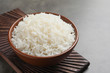 © New Africa - Bowl of tasty cooked white rice on grey table
